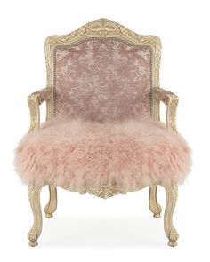 an antique chair with pink fur on it