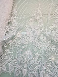 an image of white lace on fabric