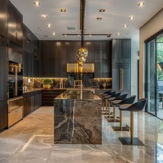 a large kitchen with marble counter tops and black chairs in front of an open window