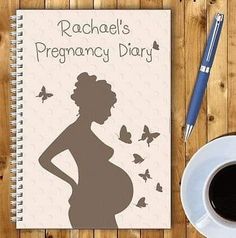 a notebook with a pregnant woman's silhouette next to a cup of coffee