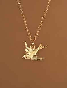 Sparrow necklace, little bird necklace in gold, swallow necklace, flying bird jewelry, a gold vermeil sparrow on a 14K gold vermeil chain A precious little gold vermeil swallow pendant hangs peacefully from a 14K gold vermeil chain in the length of your choice! Need an energy boost for your necklace? You can also add a little tourmaline drop if you like! https://www.etsy.com/listing/156969259/tourmaline-drop-energy-boost-add-a?ref=shop_home_active Looking for other charm necklaces? https://www.e Sparrow Jewelry, Swallow Necklace, Gold Necklace With Bird Design For Gift, Gold Necklace With Bird Design As Gift, Swallow Bird Jewelry, Sparrow Necklace, Bird Design Pendant Necklace Gift, Gold Pendant Necklace With Bird Design, Gold Bird Necklace