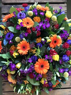 a bouquet of flowers sitting on top of a wooden table