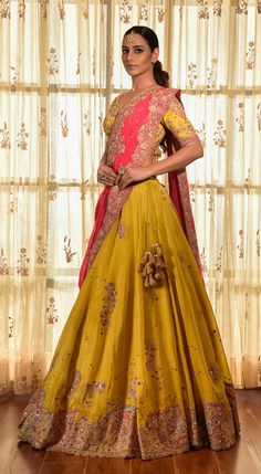 Editor's Note This set features a gorgeous greenish-yellow organza kalidar lehenga with tilla border, an organza blouse, and a red chiffon dupatta with jaal and tilla border. The intricate detailing of tilla work adds a touch of elegance to the ensemble. Fabric: Organza, chiffon Color: Yellow, red, green Components: Lehenga, blouse and dupatta Occasion: Haldi mehndi Disclaimer: Product color may slightly vary due to photographic lighting sources or your monitor setting. Care: Dry clean only Abou Yellow Chanderi Sets For Reception, Yellow Anarkali Set With Dupatta For Transitional Season, Transitional Organza Lehenga With Cutdana, Transitional Season Yellow Anarkali Set Traditional Drape, Transitional Yellow Raw Silk Anarkali Set, Yellow Chanderi Salwar Kameez For Reception, Transitional Lehenga With Pallu In Organza, Yellow Tissue Silk Sets For Transitional Season, Yellow Chanderi Traditional Wear For Reception