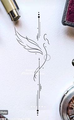 a drawing of a bird on paper next to fountain pens and inkwelling supplies