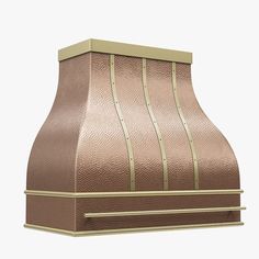 a copper colored stove hood with gold trimmings on the top and bottom, in front of a white background