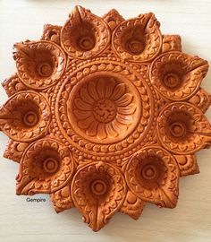 an intricately carved piece of wood on a table