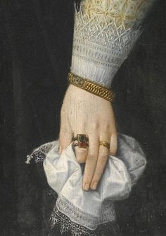 a close up of a person's hand with a ring on top of a cloth