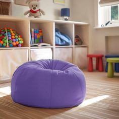 a purple bean bag sitting on top of a wooden floor