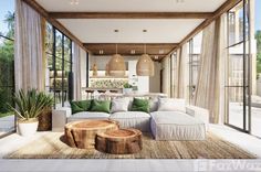 a living room filled with lots of furniture next to a large glass window covered patio