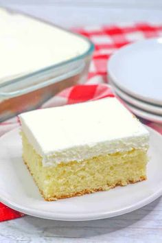 a slice of cake on a plate with red and white checkered table cloth next to it