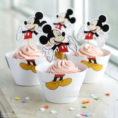 mickey mouse cupcakes with pink frosting on top