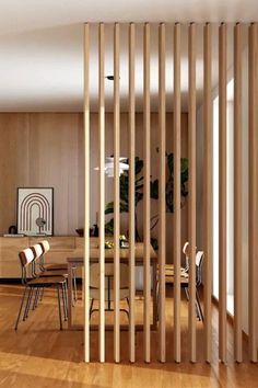 a room divider made out of wooden slats in the middle of a wood floor