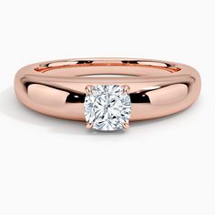 a rose gold engagement ring with a round diamond