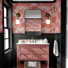 a bathroom with pink vanity, mirror and wallpaper