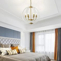 a bedroom with a large bed, chandelier and two lamps on the ceiling