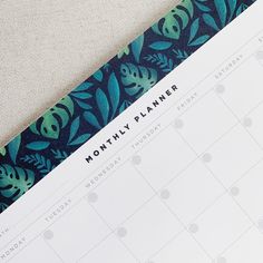 a blue and green planner with leaves on it