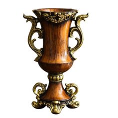 a wooden vase with ornate carvings on the top and sides, sitting against a white background