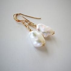 AAA Baroque Keishi freshwater pearls earrings, high gloss, natural white color, 14K Gold filled, french hooks, healing gemstone ! ... Earrings made of two beautiful Keishi freshwater pearls of 10 x 15-16 mm embellished with 14K Gold filled gold fittings. Very iridescent white natural colored pearls, undyed.    I handcrafted this classy earrings with iridescent natural white freshwater pearls, of nugget form of 10 x 15-16 mm, adorned with 14K Gold filled finding. Non-dyed natural pearls. All meta Colored Pearls, Classy Earrings, Pearls Earrings, Iridescent White, Freshwater Pearls Earrings, White Freshwater Pearl, June Birthstone, June Birth Stone, Gemstone Healing