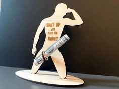 a wooden cutout of a man holding a baseball bat with the words shut up and take the money written on it