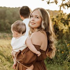 a woman holding a baby in her arms