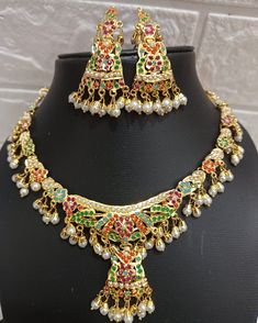 24k gold plated beautiful handmade jadau Necklace set made with craftmenship of our multi talented craftmen. Repolishable long lasting set. The product literally worth the price. Ceremonial 22k Gold Multicolor Jewelry, Festive Multicolor 22k Gold Bridal Necklace, Gold Plated Chandbali Kundan Necklace In Temple Style, Gold Plated Kundan Necklace For Festivals Temple Jewelry, Gold-plated Meenakari Chandbali Necklace, Gold Plated Meenakari Temple Necklace Chandbali, Gold Plated Meenakari Temple Necklace In Chandbali Shape, Gold Plated Meenakari Temple Necklace In Chandbali Style, Kundan Temple Jewelry Sets With Cutdana