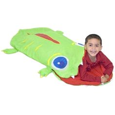 a young boy sitting on the ground with a stuffed animal