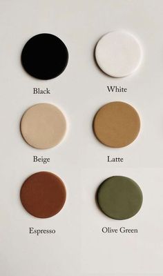 four different shades of paint on a white surface with black, white, and olive green