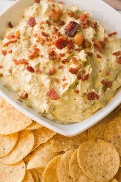 a white bowl filled with bacon dip surrounded by tortilla chips