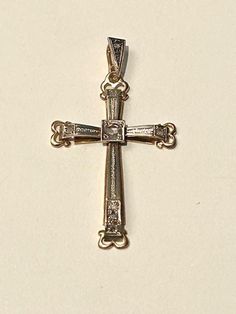 18 carat gold cross. Art Nouveau style. Two tone white and yellow gold With 8 rose cut diamond, one in the centre apr.0.10k the rest of the diamonds (7) are apr. 0.02k. The cross is hallmarked 750 for 18k gold.  The measurements are: length: 4cm, width:2.5cm. Will be sent in a jewellers box, ready for a present. Formal White Gold Cross Necklace With Diamond Cut, Anniversary White Gold Cross Necklace With Diamond Accents, White Gold Cross Necklace With Diamond Accents For Anniversary, Classic Formal Cross Necklace With Diamond Cut, Classic Diamond Cut Cross Necklace For Formal Occasions, Formal Crucifix Cross Necklace With Diamond Accents, White Gold Cross Necklace For Wedding, Formal 14k Gold Cross Jewelry And Charms, Formal Yellow Gold Cross Necklace With Diamond Accents