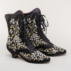 Now available in wide width! Indulge in a piece of history with Flora Embroidered Boots, an exclusive reproduction of the intricate opera and evening boots popular in the late Victorian period. Expertly crafted with intricate botanical detailing, these stunning satin boots will take you back to an era of sophistication and finesse. Wear them with bustle and Belle Epoque attire from the 1870s to c. 1900, or with modern dress as a statement piece. The Flora Boots are designed in collaboration with Satin Boots, House Of Mirth, The House Of Mirth, Bata Shoes, American Duchess, Button Boots, Hats Hairstyles, Oxford Pumps, Boots Wide