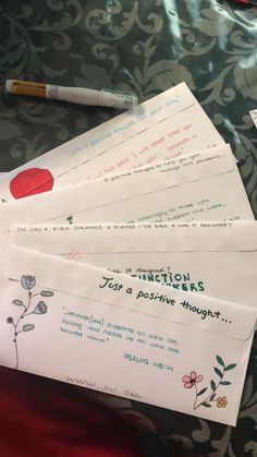 four envelopes with writing on them sitting on a table