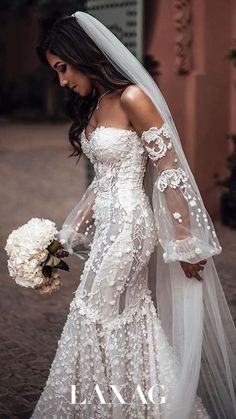 a woman in a wedding dress holding a bouquet