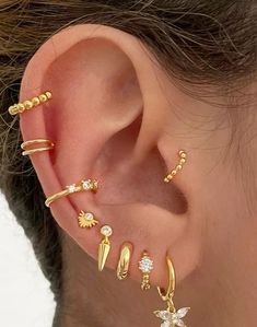 an ear with three different types of piercings attached to the side of its ear