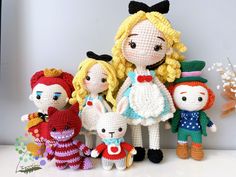 a group of crocheted dolls sitting next to each other