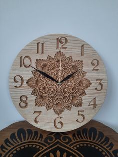 a wooden clock sitting on top of a table