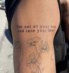 a person with a tattoo saying get out of your head and into your heart