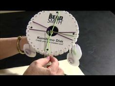 a person holding up a clock made out of some sort of parts that are attached to each other