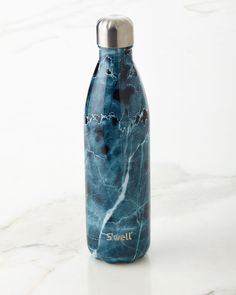 a blue marbled water bottle with the word swell on it