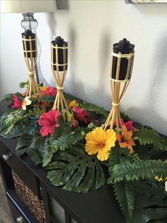 some plants and flowers are sitting on a table