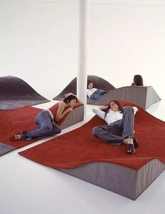 two women are laying on the ground in front of mirrors and rugs that look like they're reclining