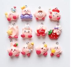 a bunch of little pig charms sitting on top of a white table next to each other