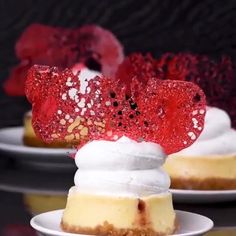 two small desserts on white plates topped with whipped cream and raspberry topping