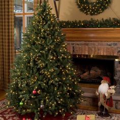 there is a christmas tree in the living room next to a fire place with presents on it