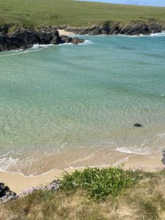 the water is crystal green and clear at this beach near an island in the middle of the ocean