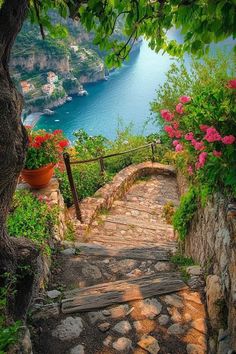 the stairs lead up to an outdoor area with flowers and greenery on either side