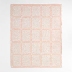 an orange and white rug with squares on it