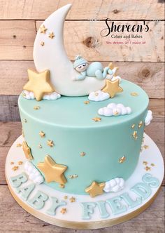 a blue cake with gold stars and a moon on top