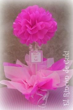 a pink flower in a clear vase on top of a table