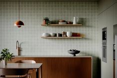 the kitchen is clean and ready to be used for dinner or lunchtime, with shelves on either side of the counter