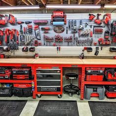 a garage filled with lots of tools and workbenches on the wall next to each other